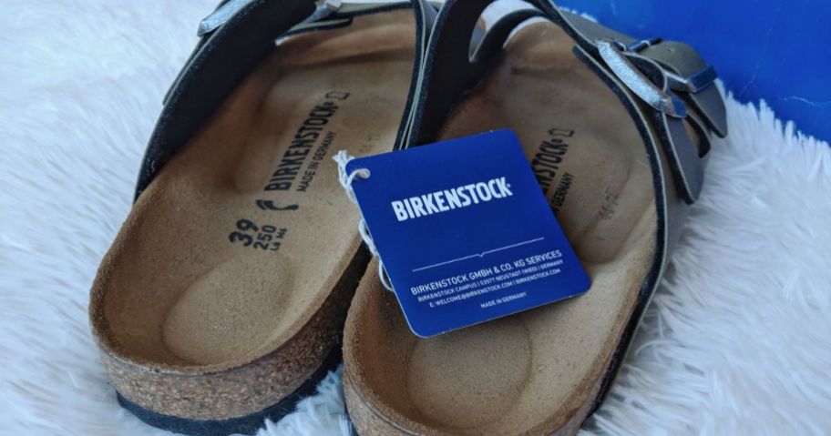 Back view of a brand new pair of Birkenstocks with the tag on them