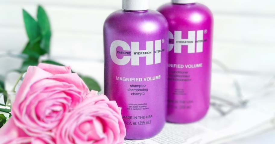chi magnified volume shampoo bottle with conditioner and roses in bathroom