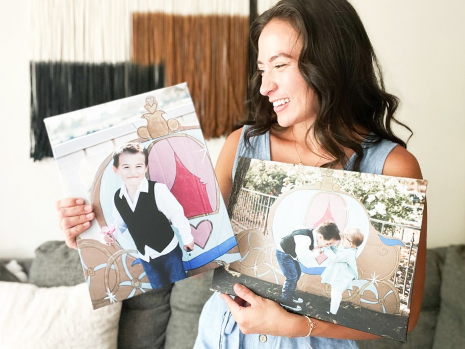 woman holding up and looking at two canvas prints