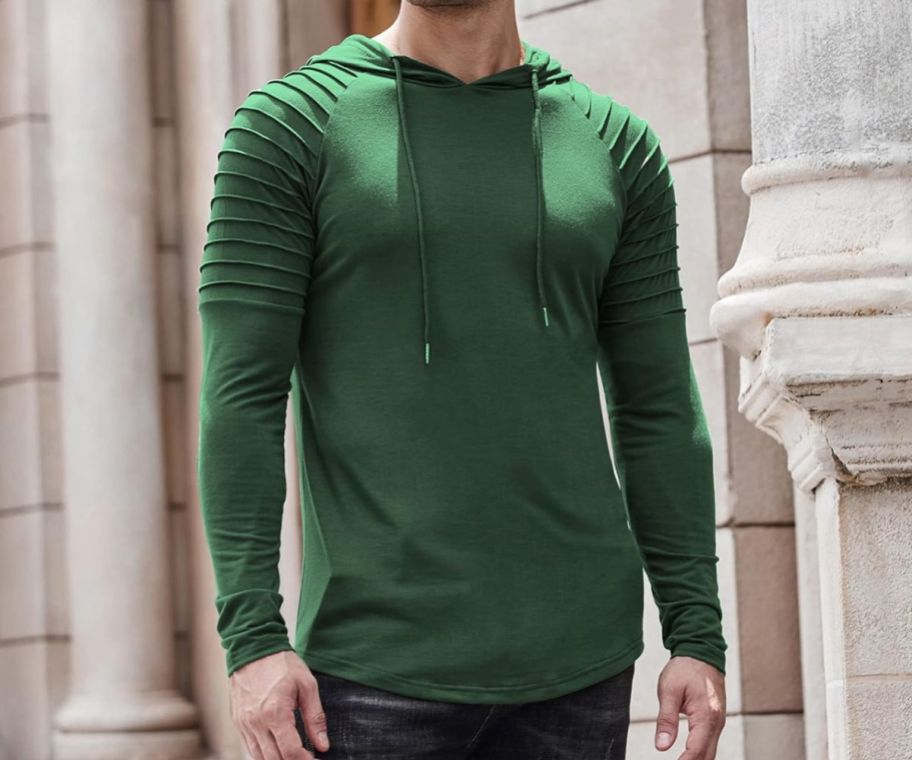A man wearing a Coffandy Men's Muscle Hoodies in green
