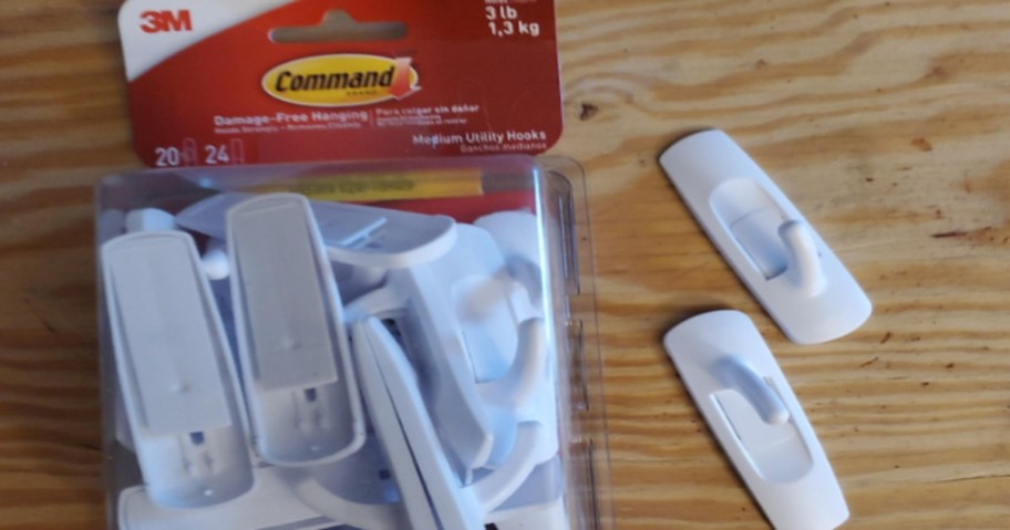 Pack of White Command Utility Hooks with two outside of the package.