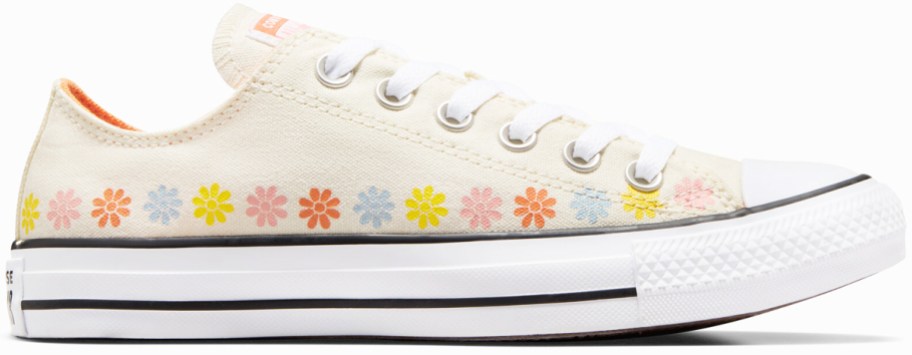 cream colored low top converse sneaker with orange, pink, blue, and yellow flower print