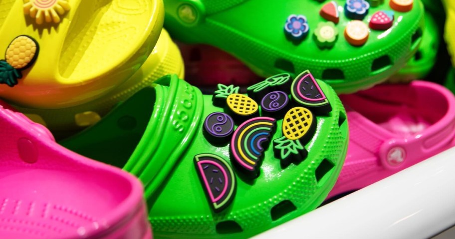 neon crocs clogs covered in jibbitz charms
