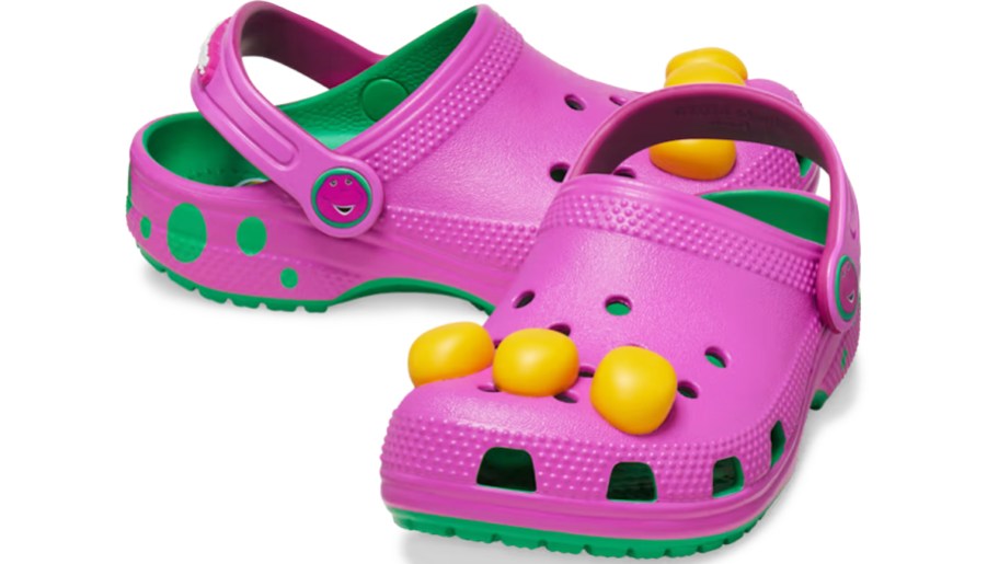 pair of purple and green Crocs Barney clogs