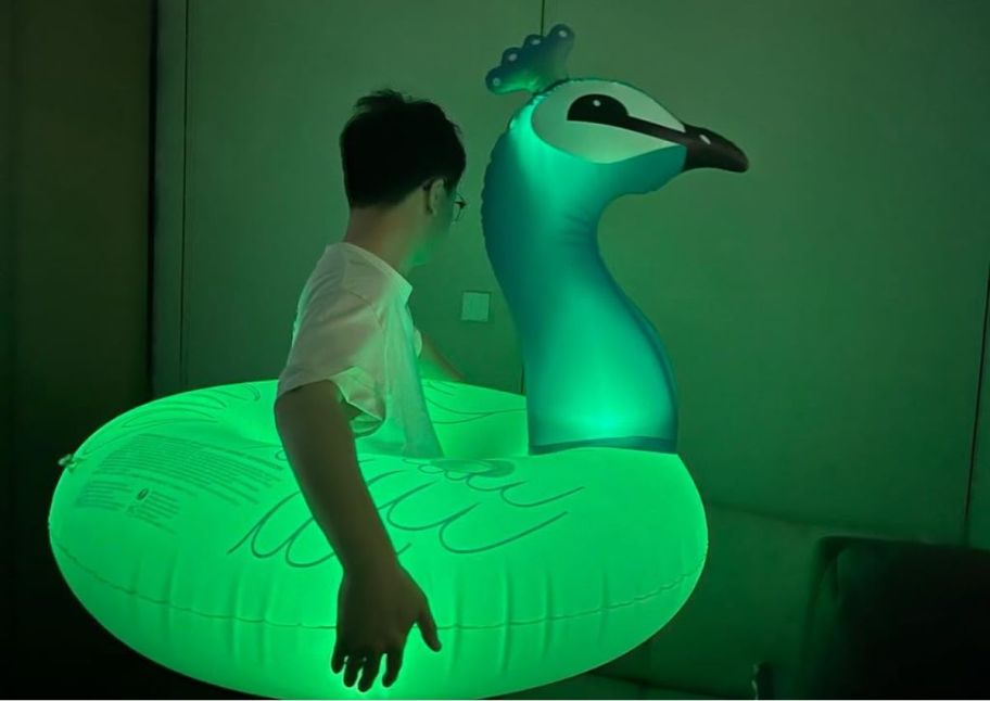 a person wearing a light up peacock pool float