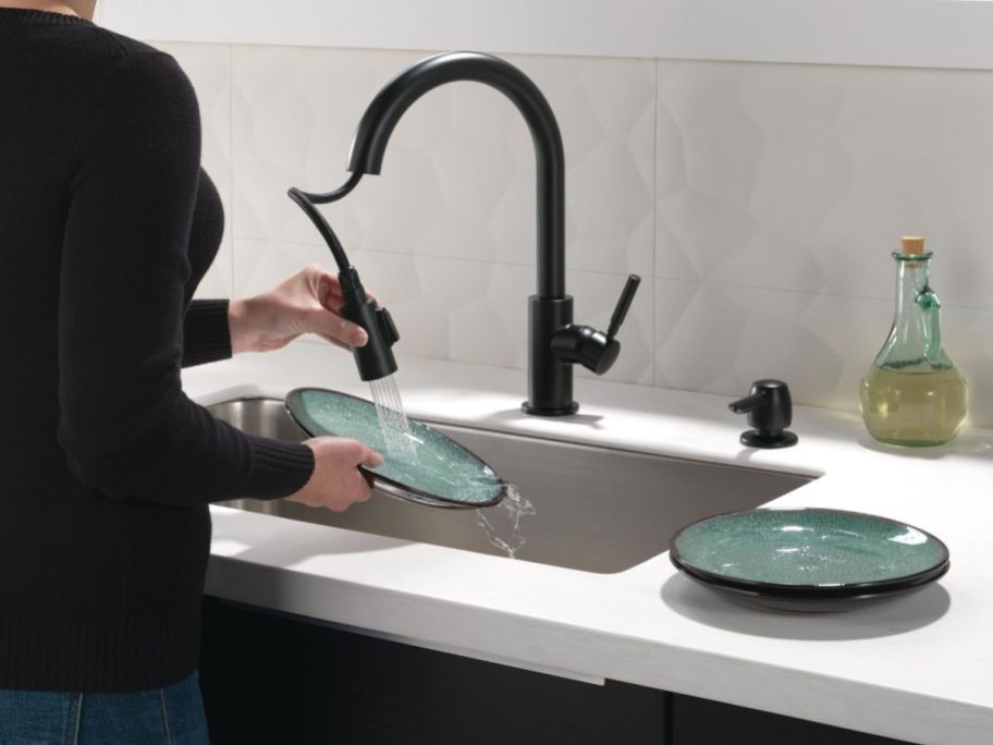 person usin Single Pull-down Kitchen Faucet