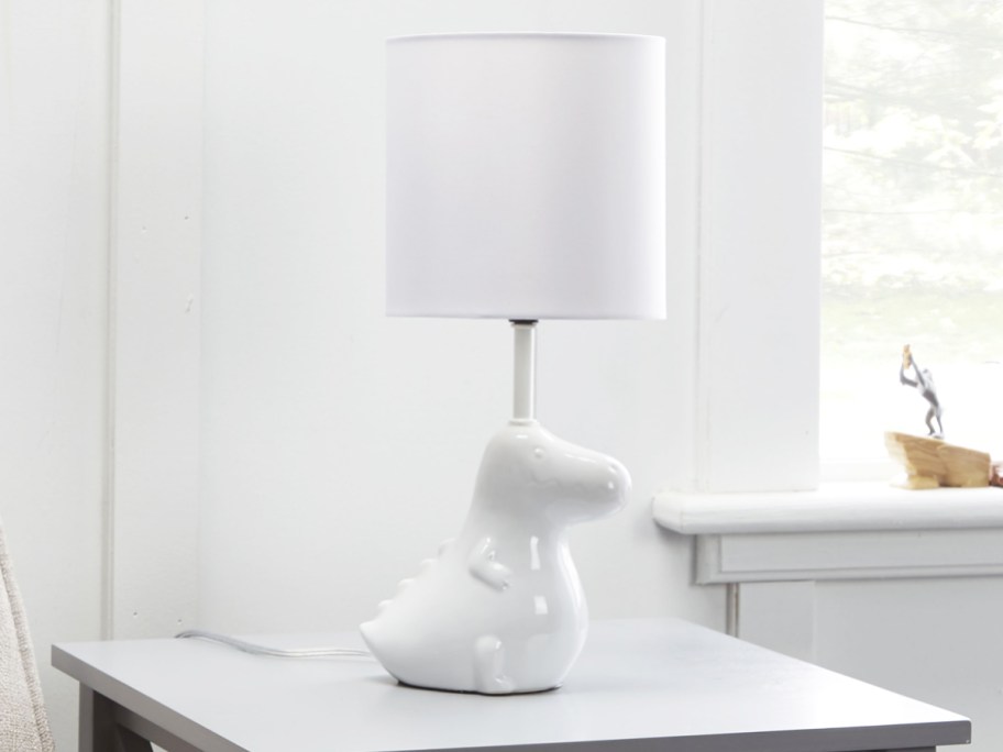 white dinosaur lamp on side table