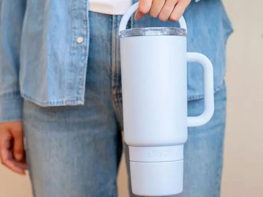Hand carrying a light blue Ello port tumbler by the top carry loop