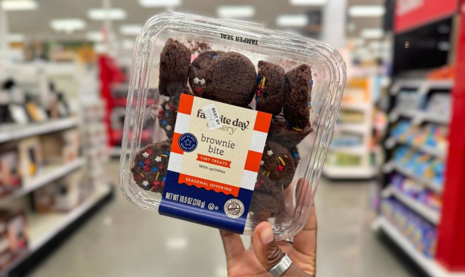 a womans hand holding a package sprinkle brownie bites