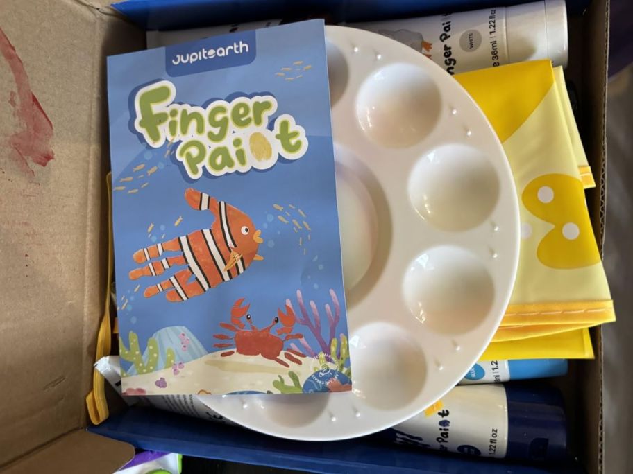 box opened up with Finger paint items inside of it