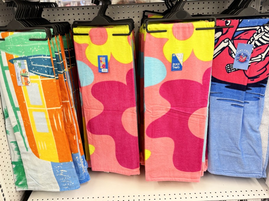 printed beach towels on display in five below store