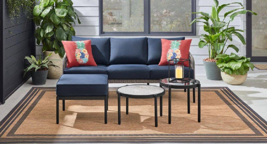 Four piece patio set on a run with plants surrounding it
