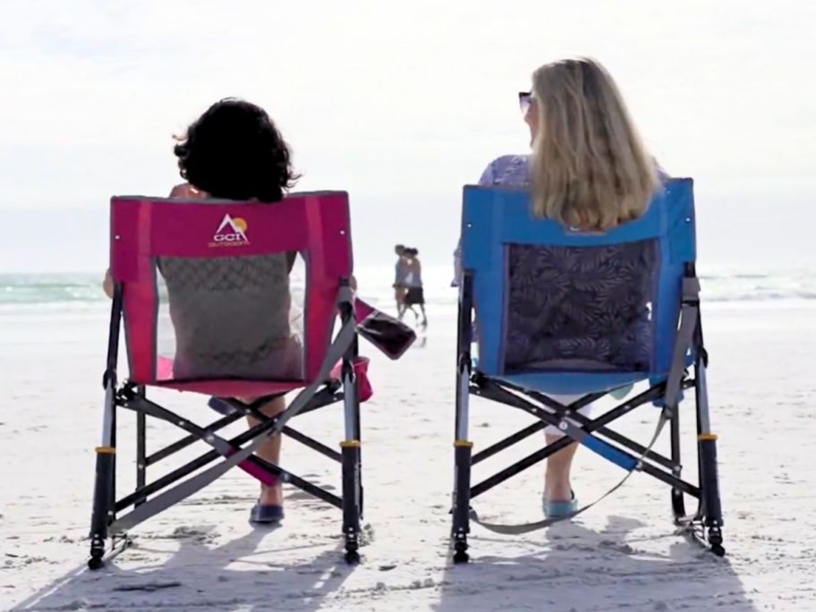 2 women sitting on the beach in a GCI rocker