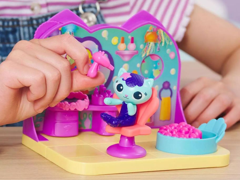 girl playing with Gabby's Dollhouse MerCat's Spa Room Playset