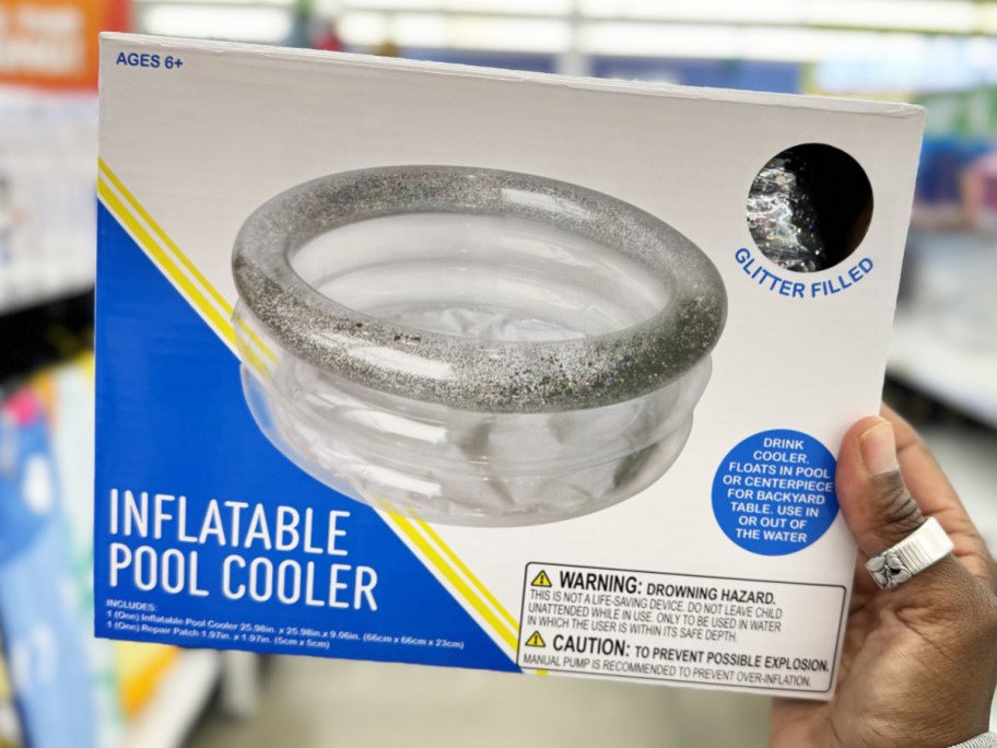 hand holding up a silver glitter inflatable pool cooler