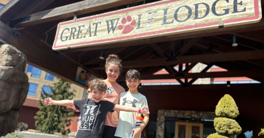 3 kids in front of the Great Wolf Lodge Entrance