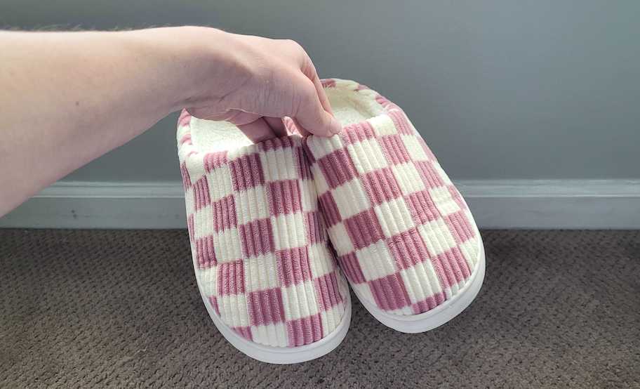 hand holding pink and white checked slippers