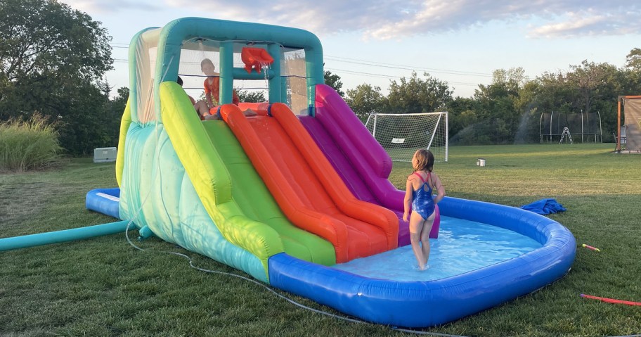 kids playing on large inflatable water park