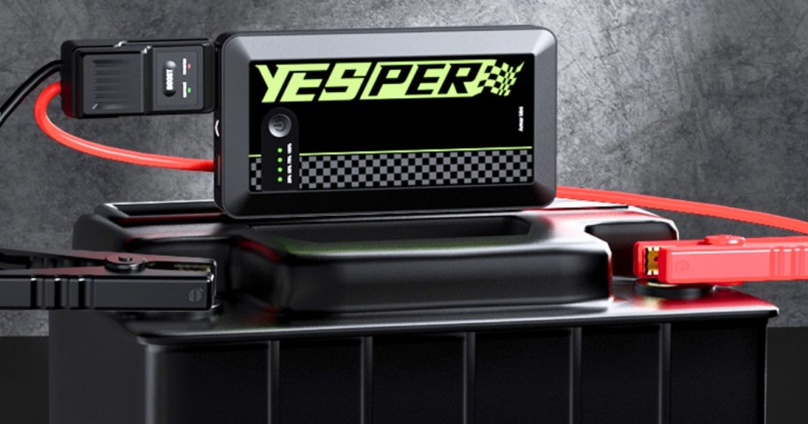 Yesper battery charger shown with cables attached to a car battery