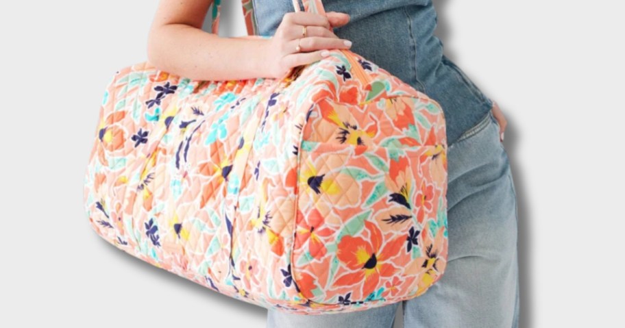 woman with a multi-color Vera Bradley large duffel bag on her shoulder