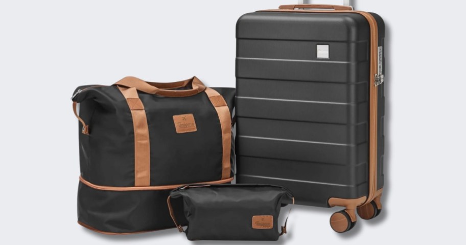 black luggage set with brown details, duffle bag, toiletry bag and hard-sided carry on suitcase