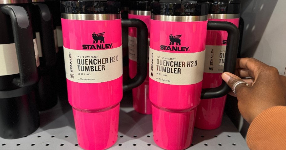 neon pink and black Stanley Tumblers on shelf