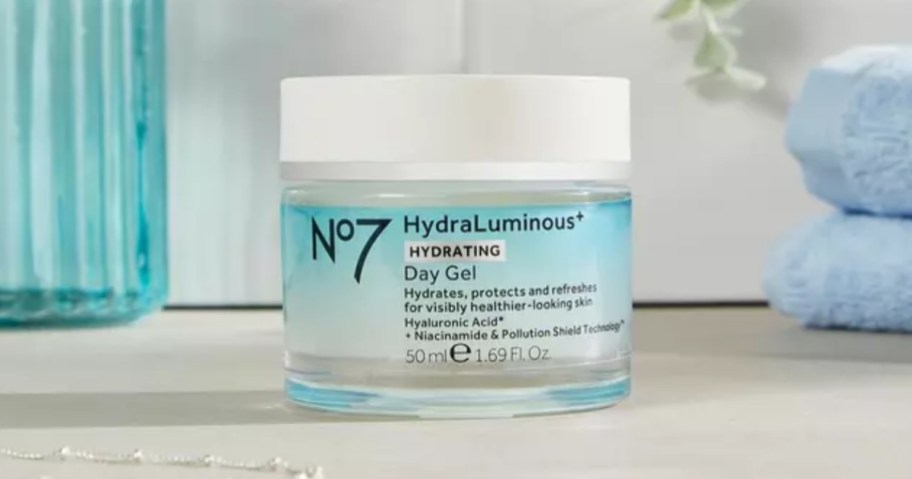 blue and white jar of No7 HydraLuminous+ Hydrating Day Gel on a bathroom counter