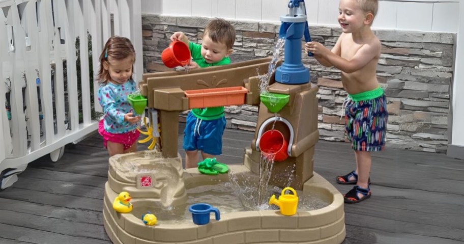 kids playing with a kids water table splash pond play set