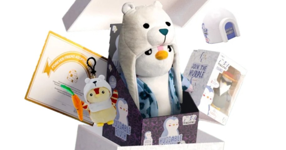 Pudgy Penguin plush, small figure and collector card coming out of a box