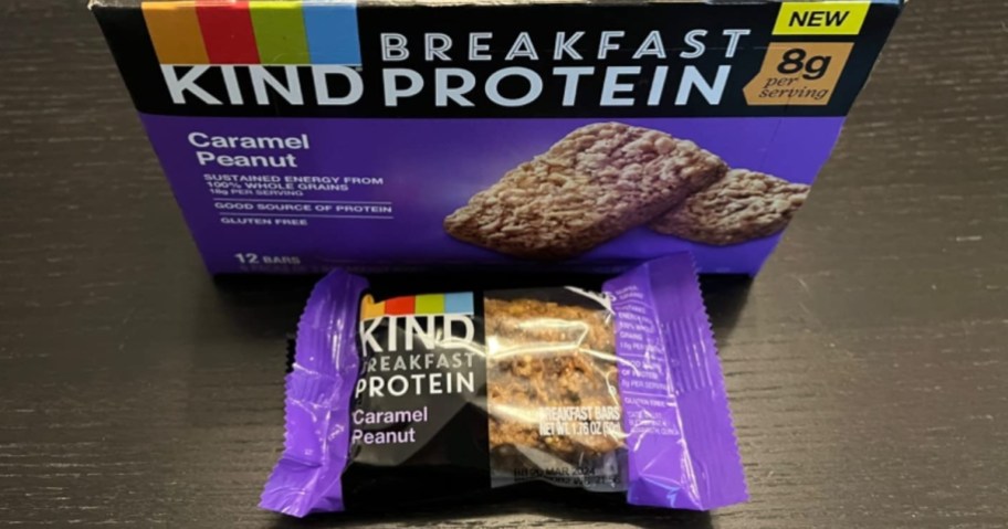 box of KIND Breakfast Protein Bars, Caramel Peanut with 1 individual wrapped bar pack in front of it
