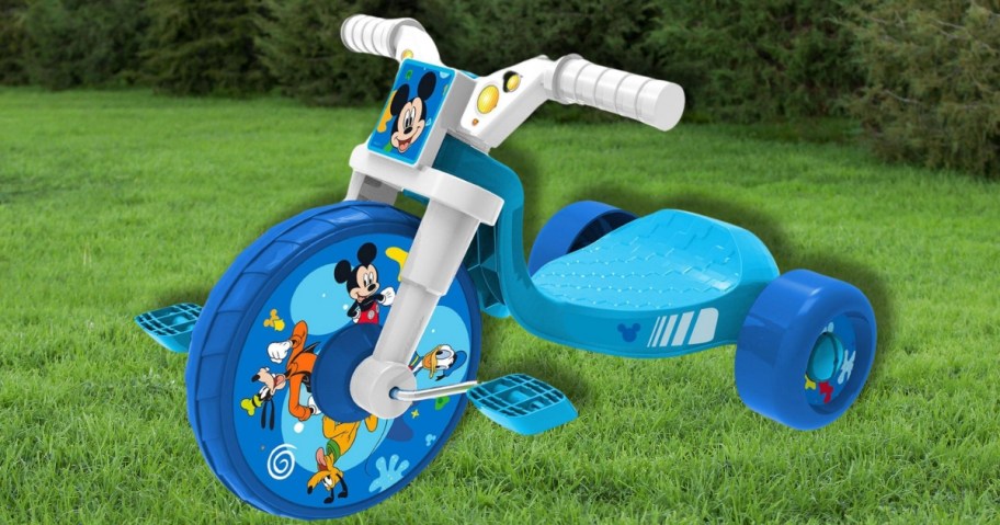 a kids low ride tricycle in blue with Mickey Mouse decals