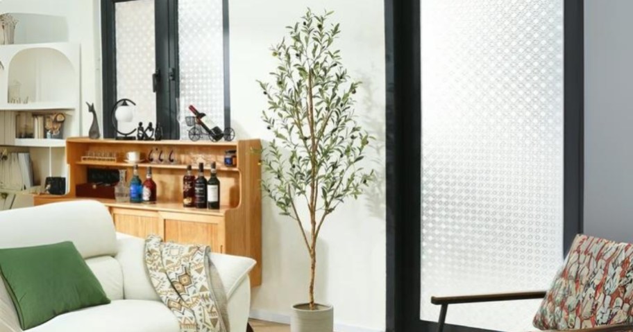 faux olive tree plant in a living room