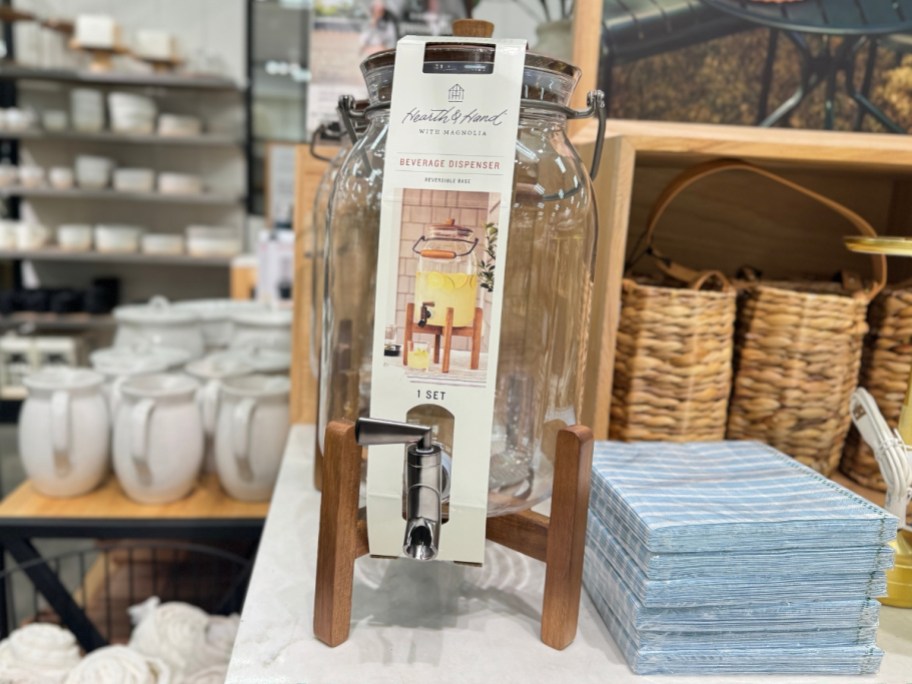 glass beverage dispenser on a wooden stand on display at Target