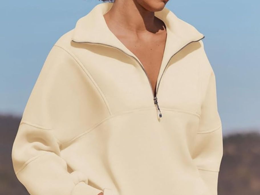 woman wearing white half-zip fleece pullover sweatshirt