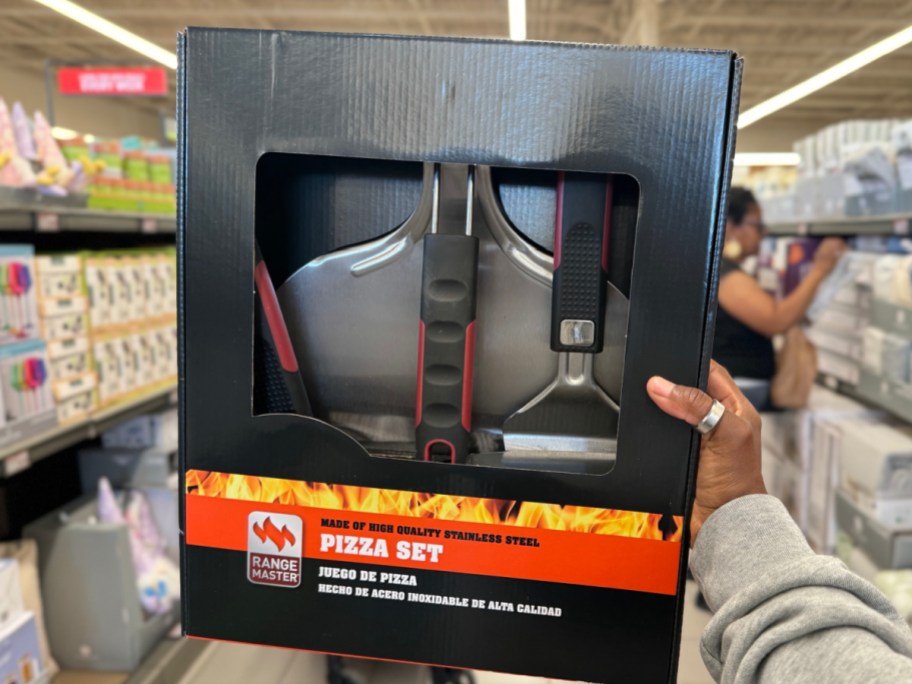 Hand holding pizza set at ALDIs store