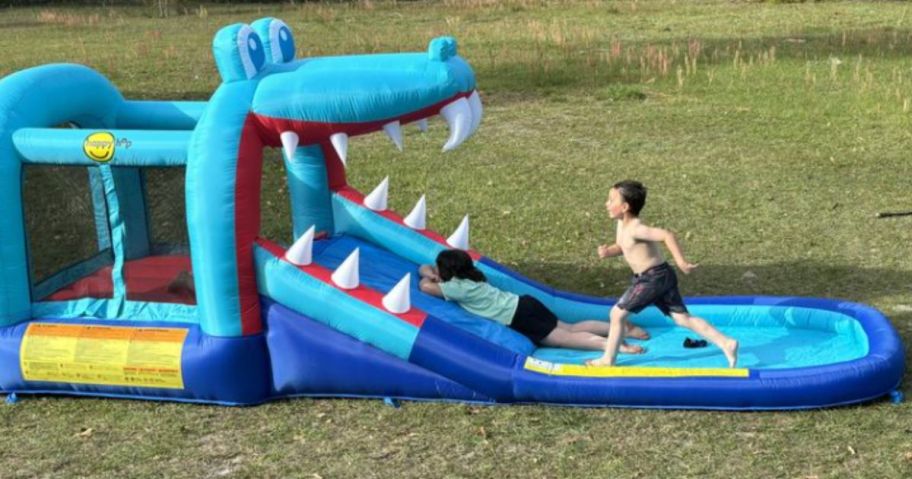 Kids paying in a Happy Hop Water Slide Jumping Castle & Pool