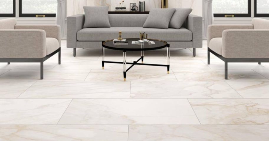 Tile flooring in a living room with a couch, coffee table and chairs