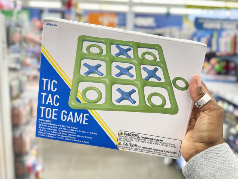 hand holding up a green and blue Inflatable Tic Tac Toe Game