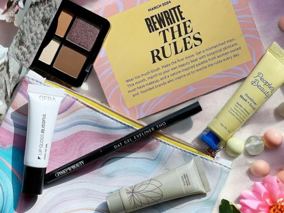An Ipsy Glam Bag with 5 deluxe size beauty products and a makeup bag