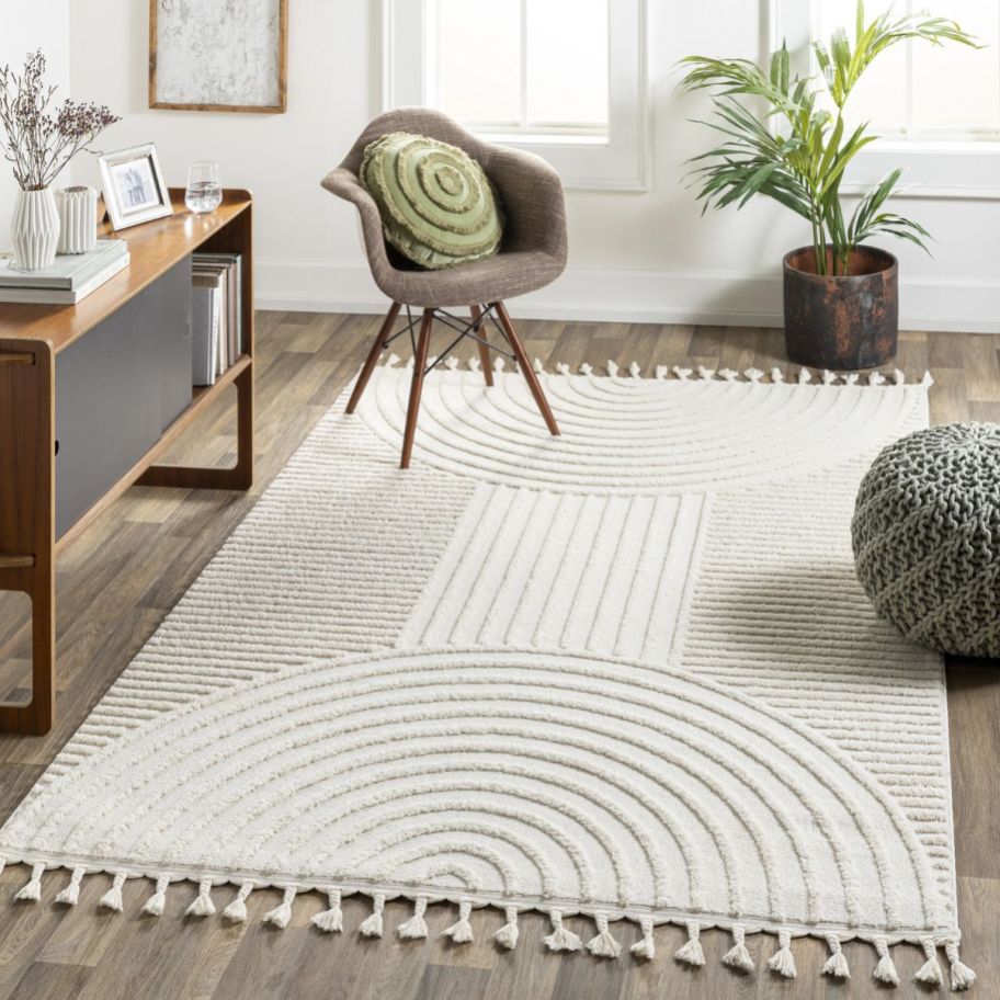 a cream colored textured rug in a living room