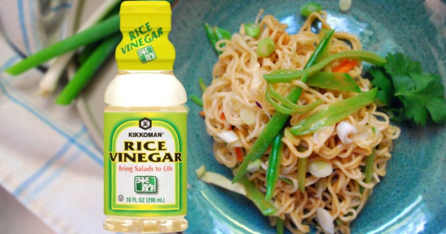 A bottle of Kikkoman Rice Vinegar with a noodle dish
