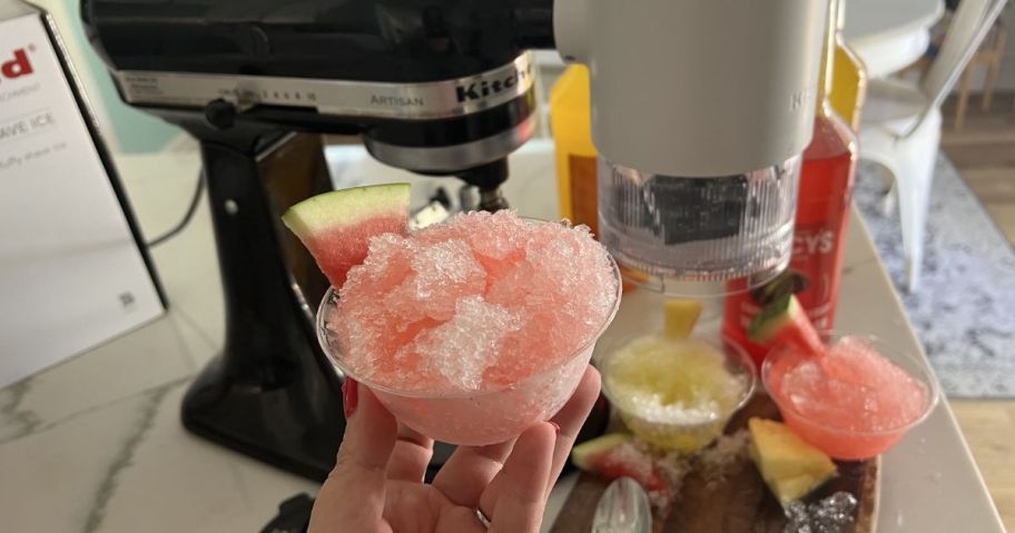 hand holding cup of shaved ice made with KitchenAid Shaved Ice Stand Mixer Attachment