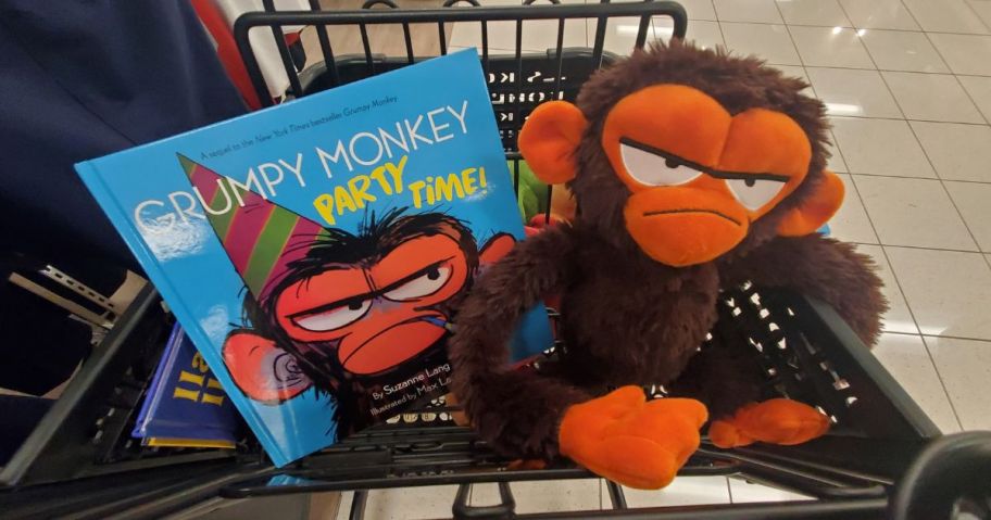 A Kohls Cares Plush Grumpy Monkey and book in a cart