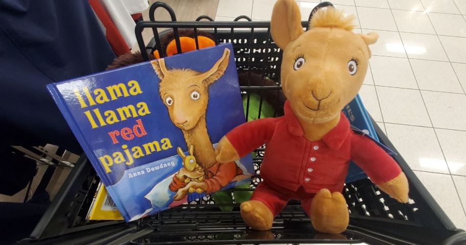 A Kohls Cares Plush Llama and book in a cart