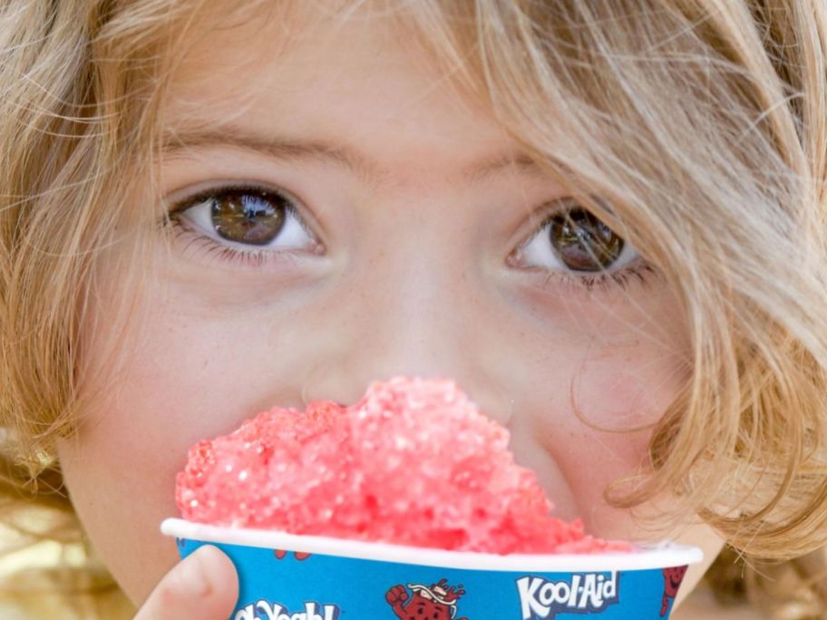 A child eating a Kool-Aid snow cone cup