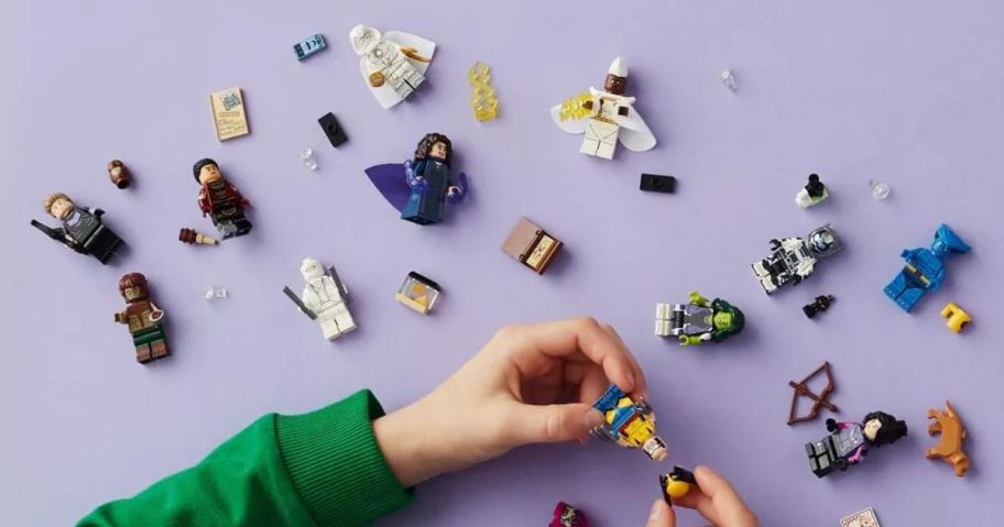 A child building a bunch of LEGO minifigures