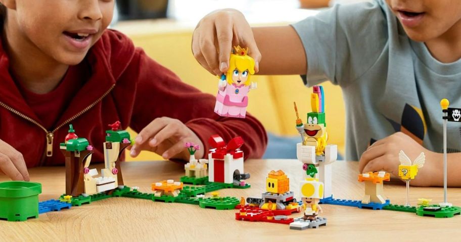 Kids playing with a LEGO Super Mario Adventures with Peach Starter Course