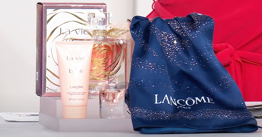 Lancome La Vie Est Belle perfume, mini bottle, lotion, and blue scarf