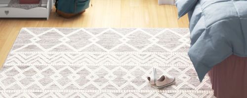 geometric print rug next to bed