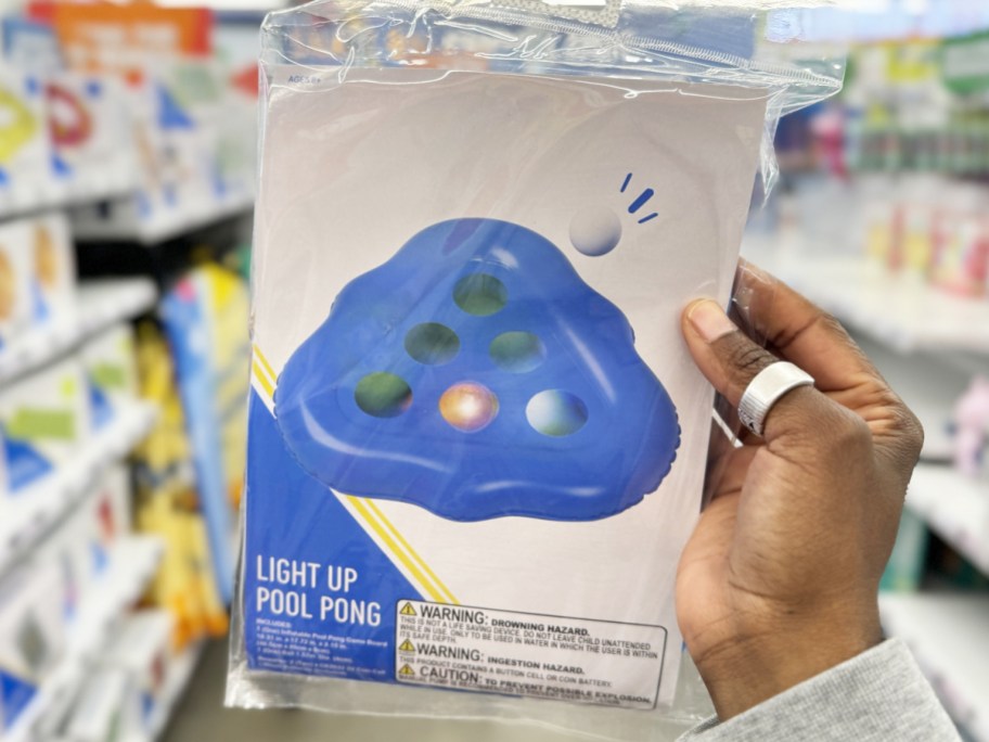 hand holding up blue Light Up Pool Pong game